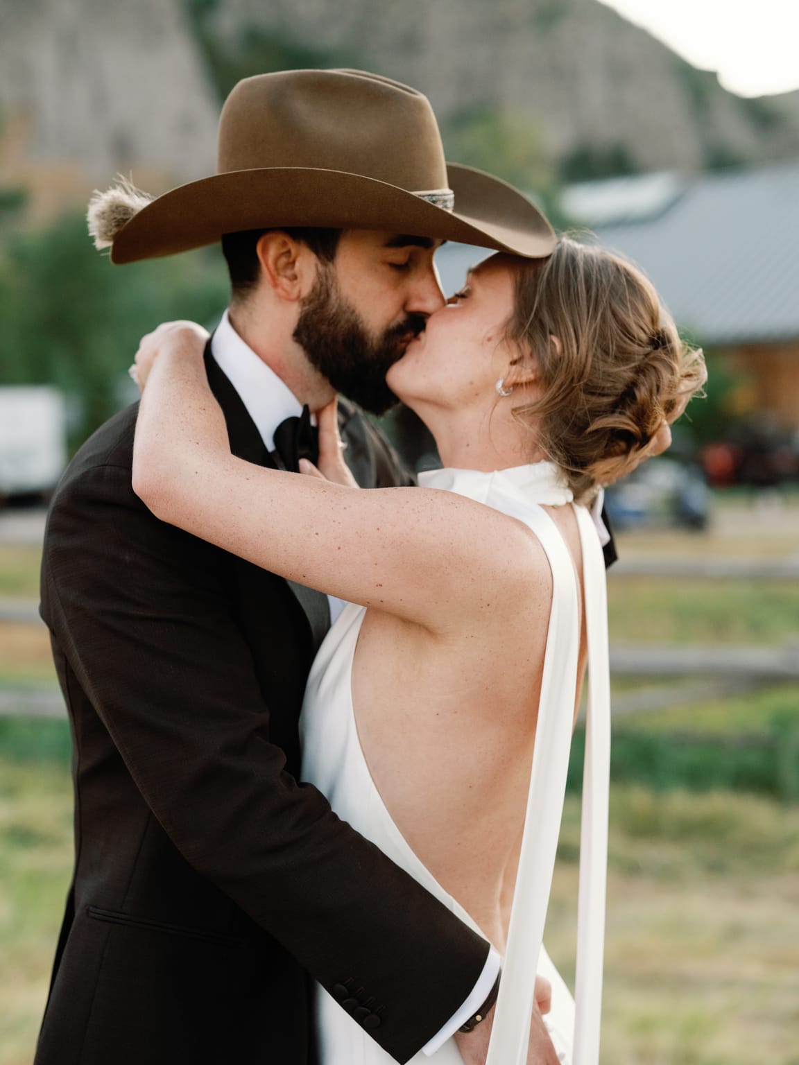 The groom in a cowboy hat dips the bride for a kiss, a 4U Ranch wedding in Park City, Utah