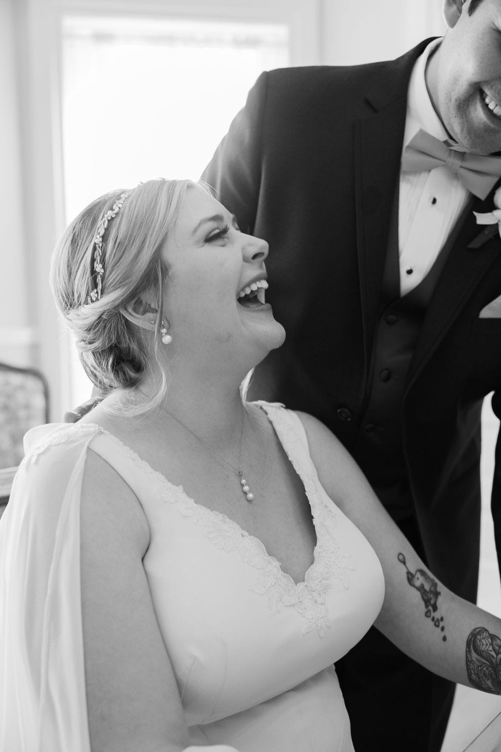 Grace and Miles wedding at Eldredge Manor, signing the marriage license, the bride laughing