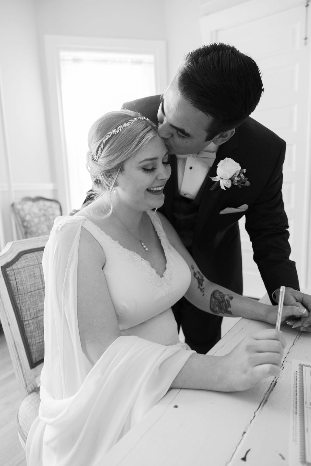 Grace and Miles wedding at Eldredge Manor, a quiet moment during the signing, black and white