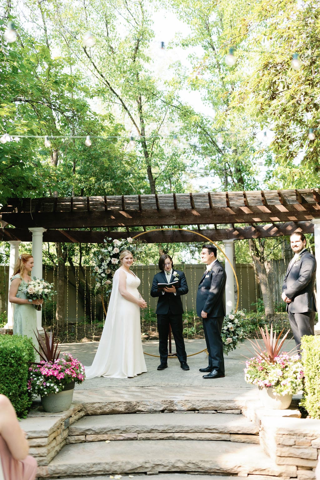 Grace and Miles wedding at Eldredge Manor, the garden ceremony beneath the pergola