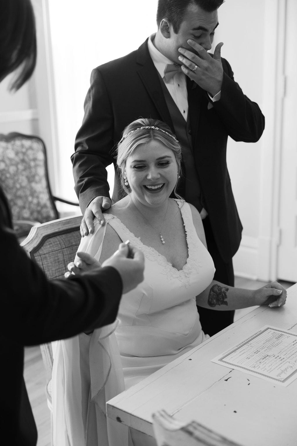 Grace and Miles wedding at Eldredge Manor, a tender moment at the signing, black and white