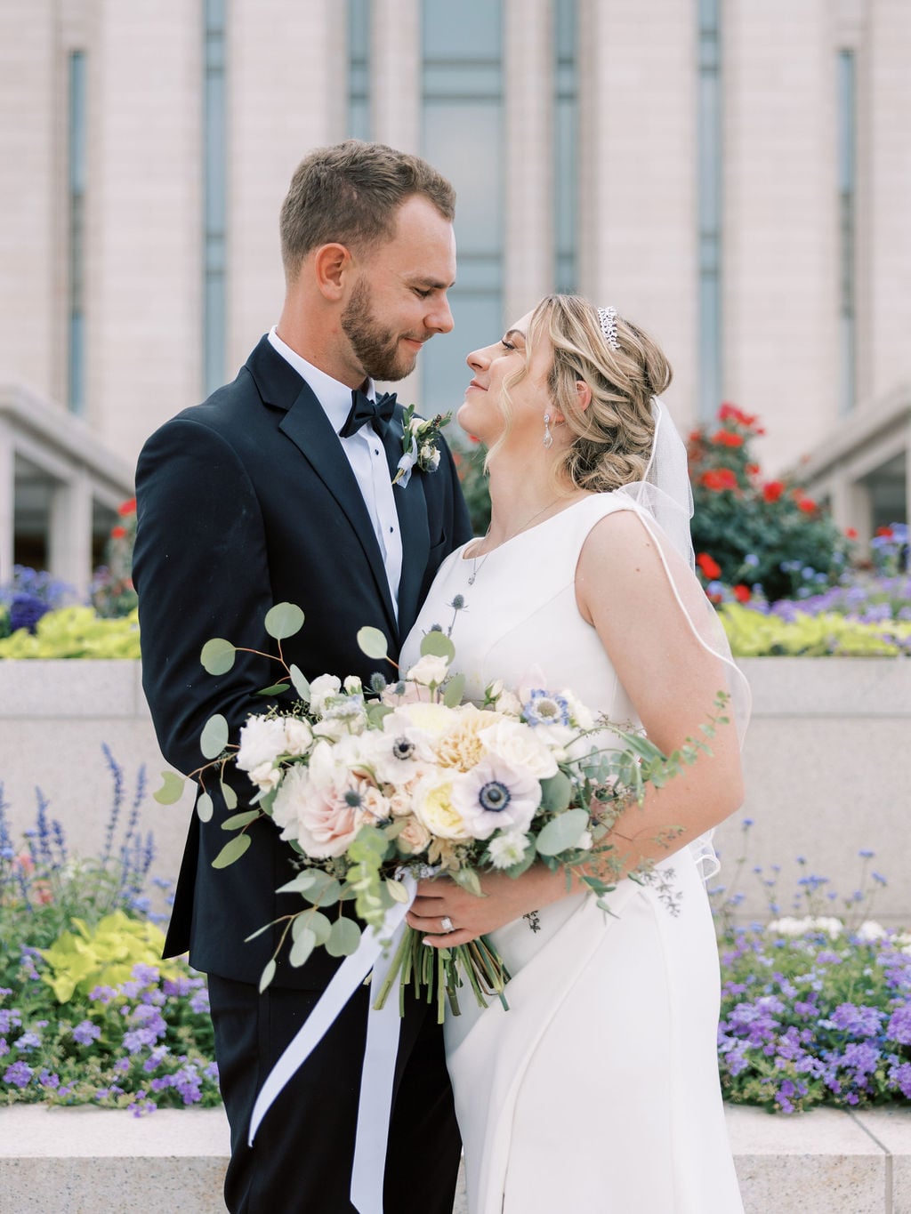 Joe and Holly wedding, the couple with the bridal bouquet at the temple