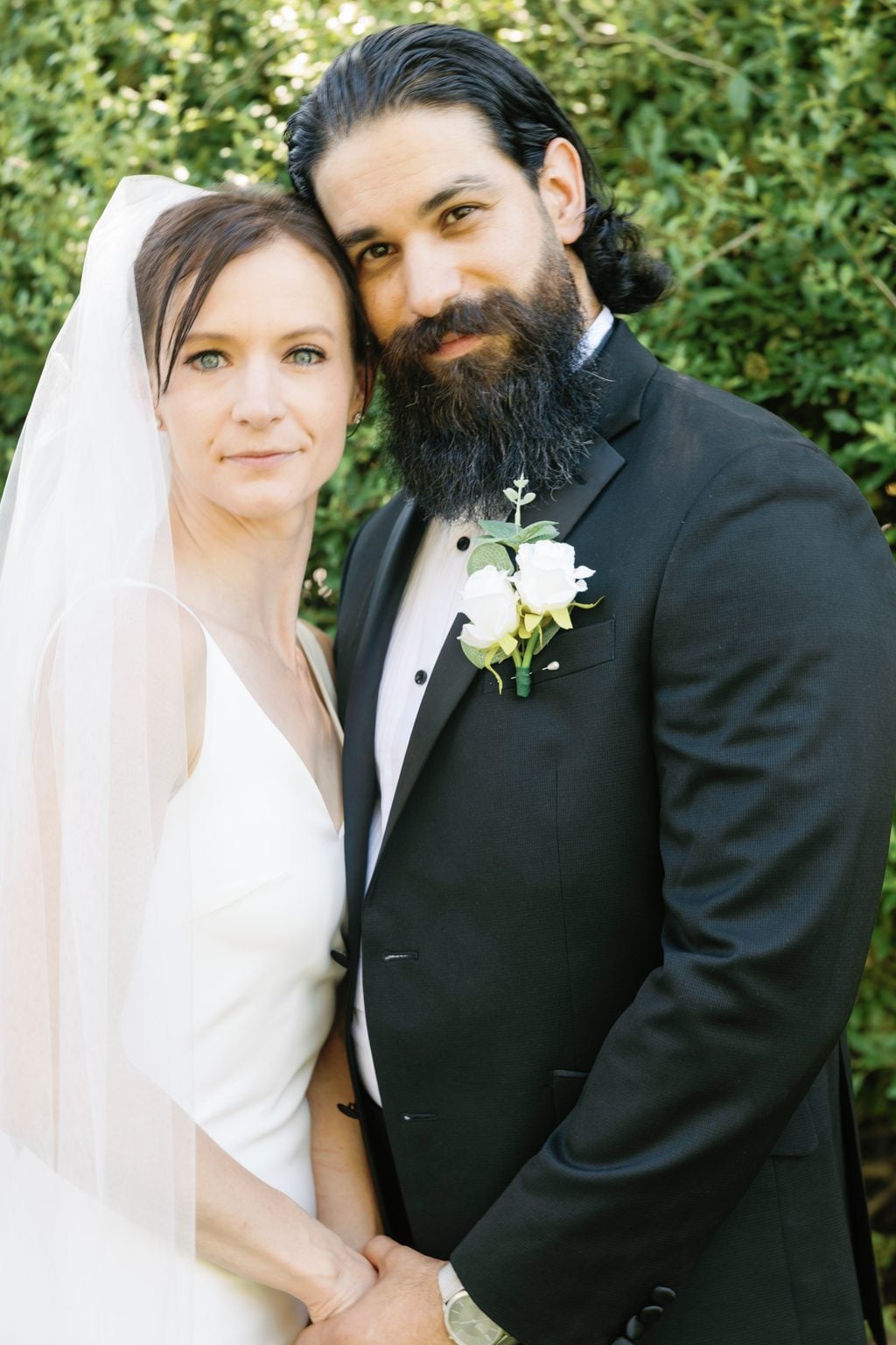 An intimate portrait of Mallory and Saint, close and quiet in the garden
