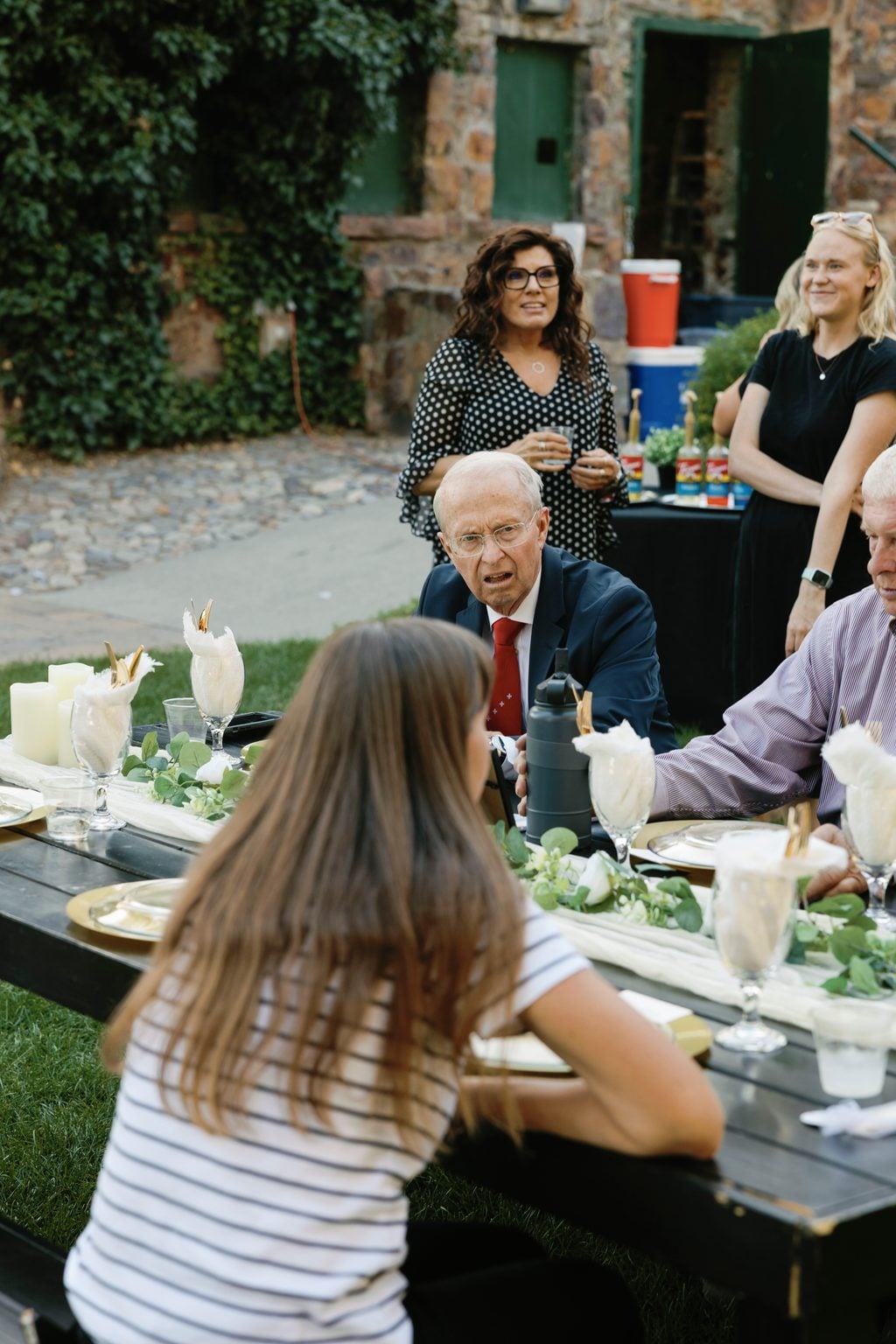 Guests gathered for the open-air reception in golden evening light