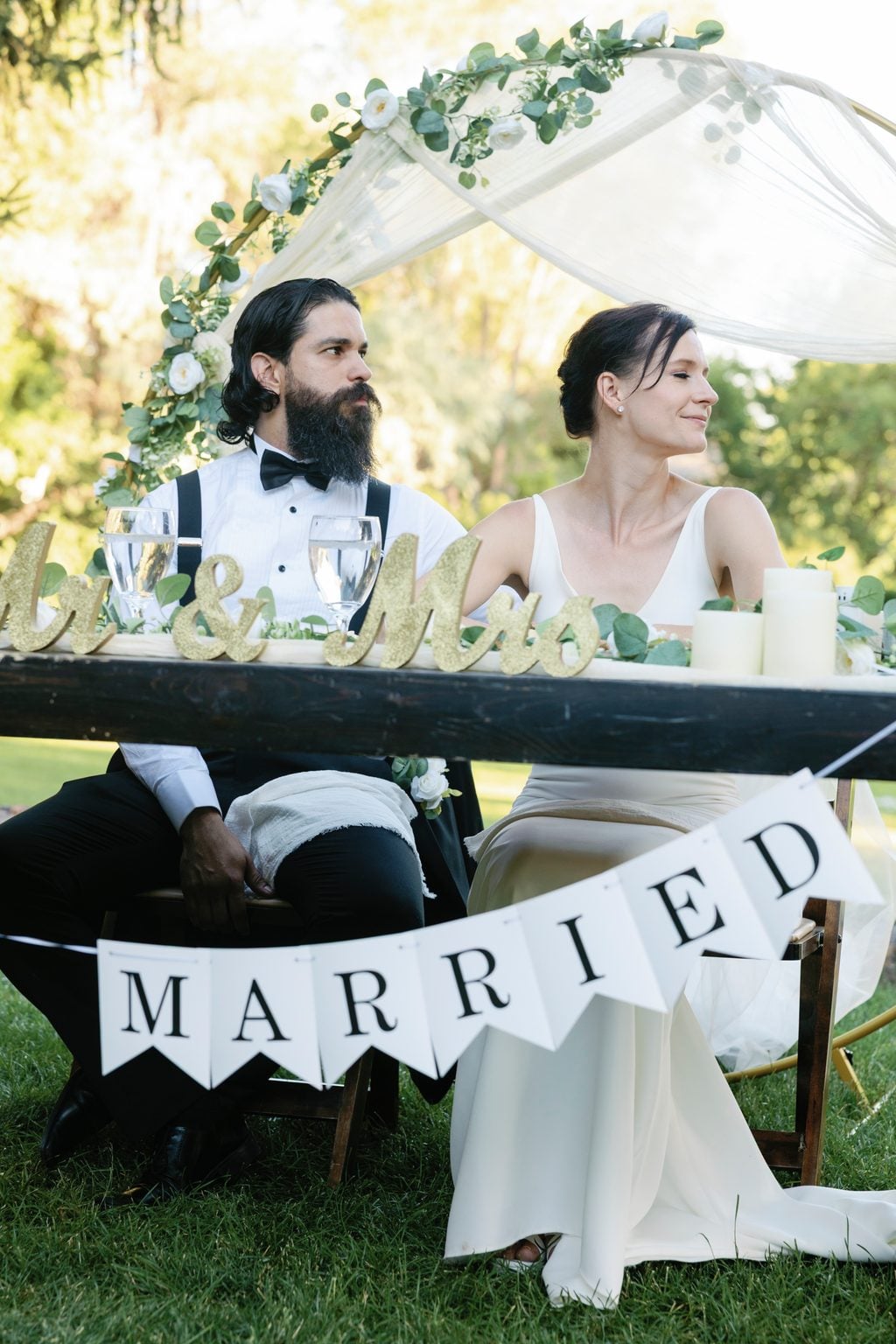 A 'Married' banner strung across the couple's chairs at the reception