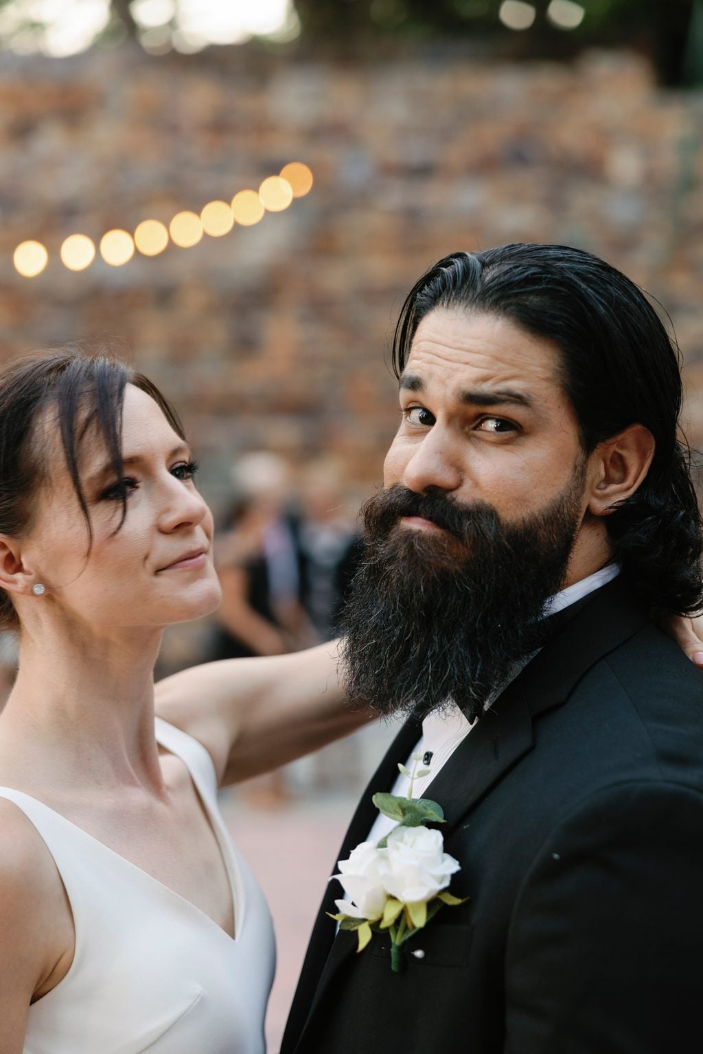 The couple embracing during their first dance, the bride in an open-back gown