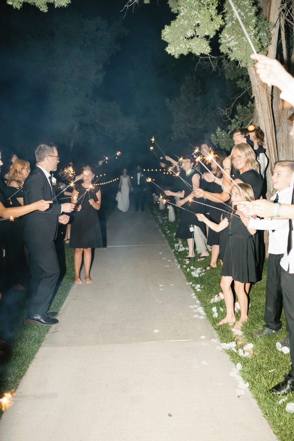 Guests lining the path with sparklers for the send-off, a night garden exit
