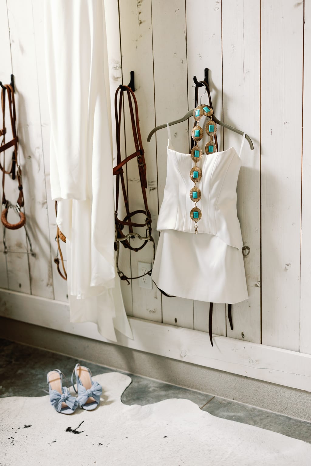 The wedding gown hanging against a rustic ranch wall, 4U Ranch wedding in Park City, Utah
