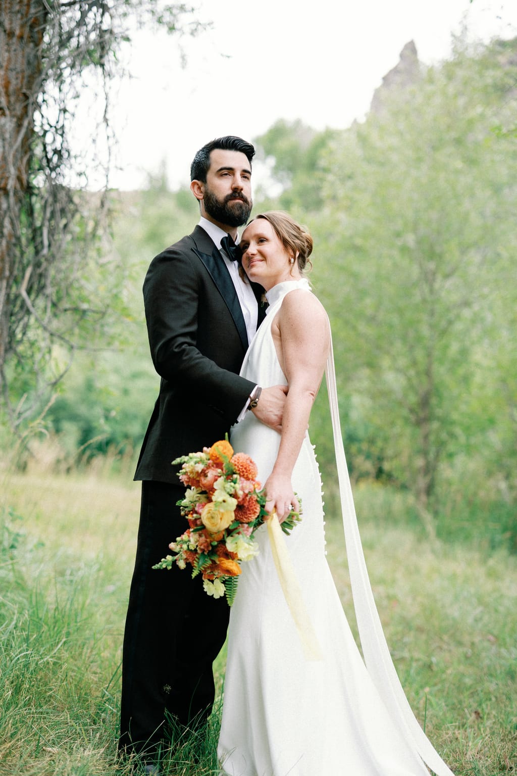Bride and groom portrait in the meadow with mountains beyond, 4U Ranch wedding, Park City Utah