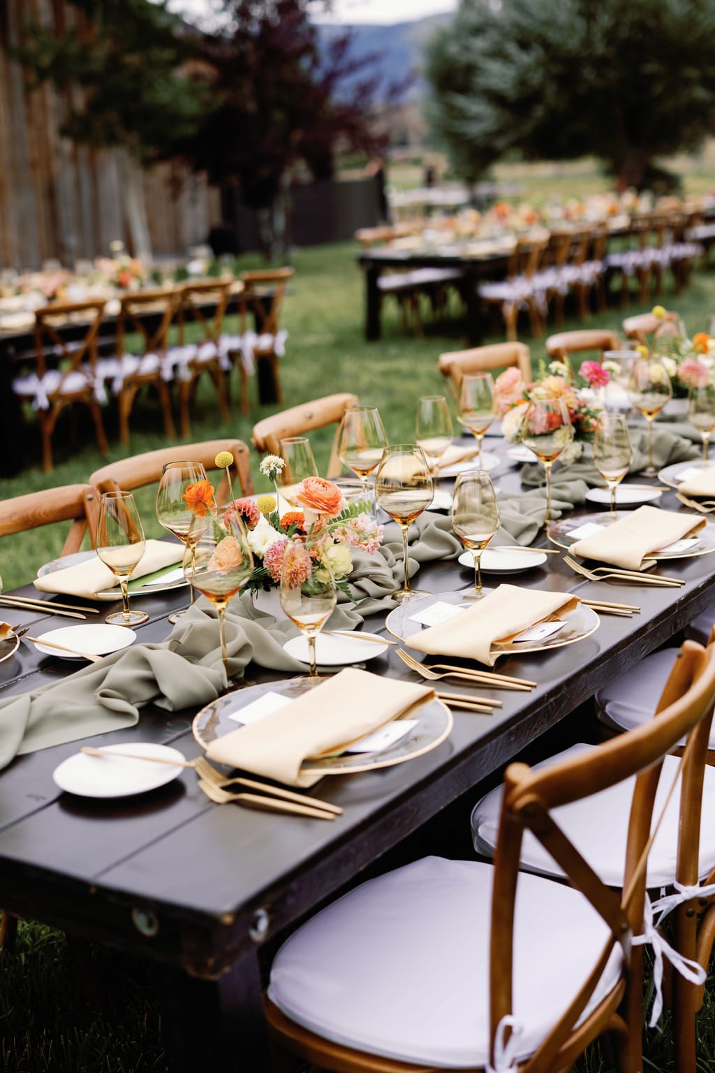 Farm-table reception set under the trees at a 4U Ranch wedding in Park City, Utah