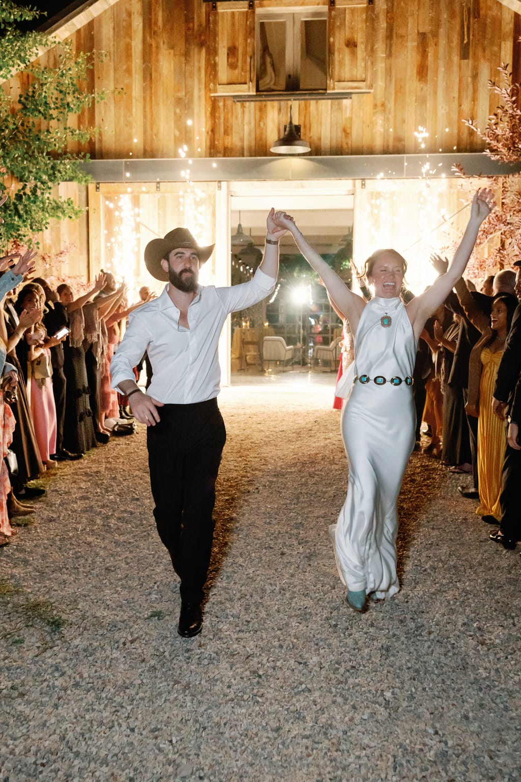 The couple walk through the string-lit barn at night, 4U Ranch wedding, Park City Utah