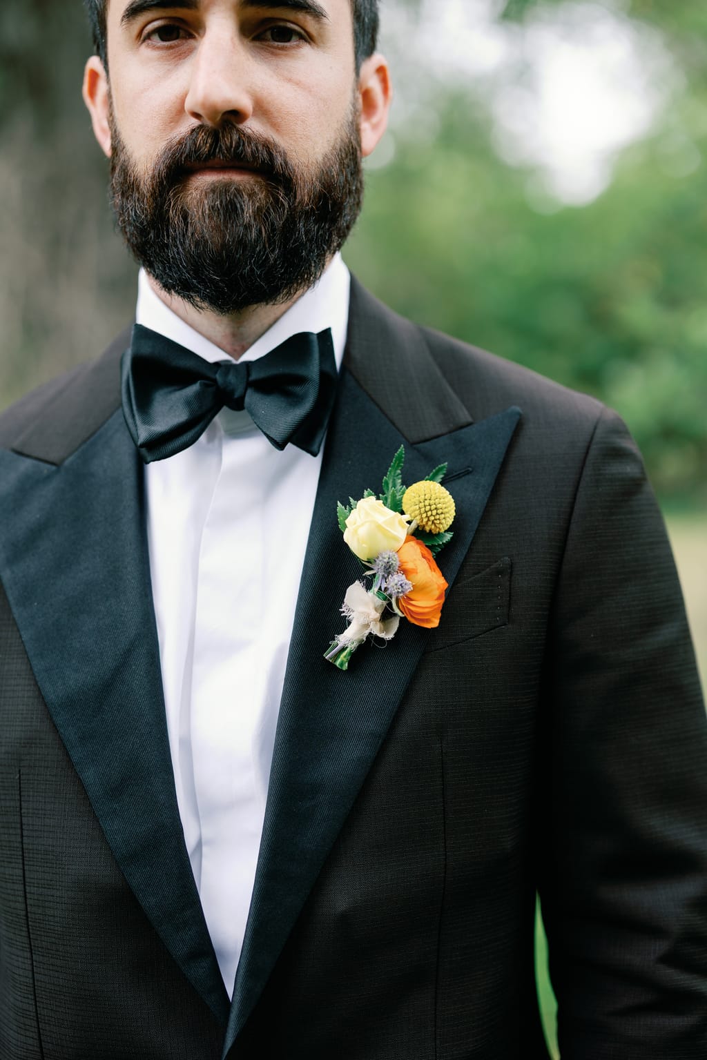 The groom's marigold boutonniere, a detail from a 4U Ranch wedding in Park City, Utah