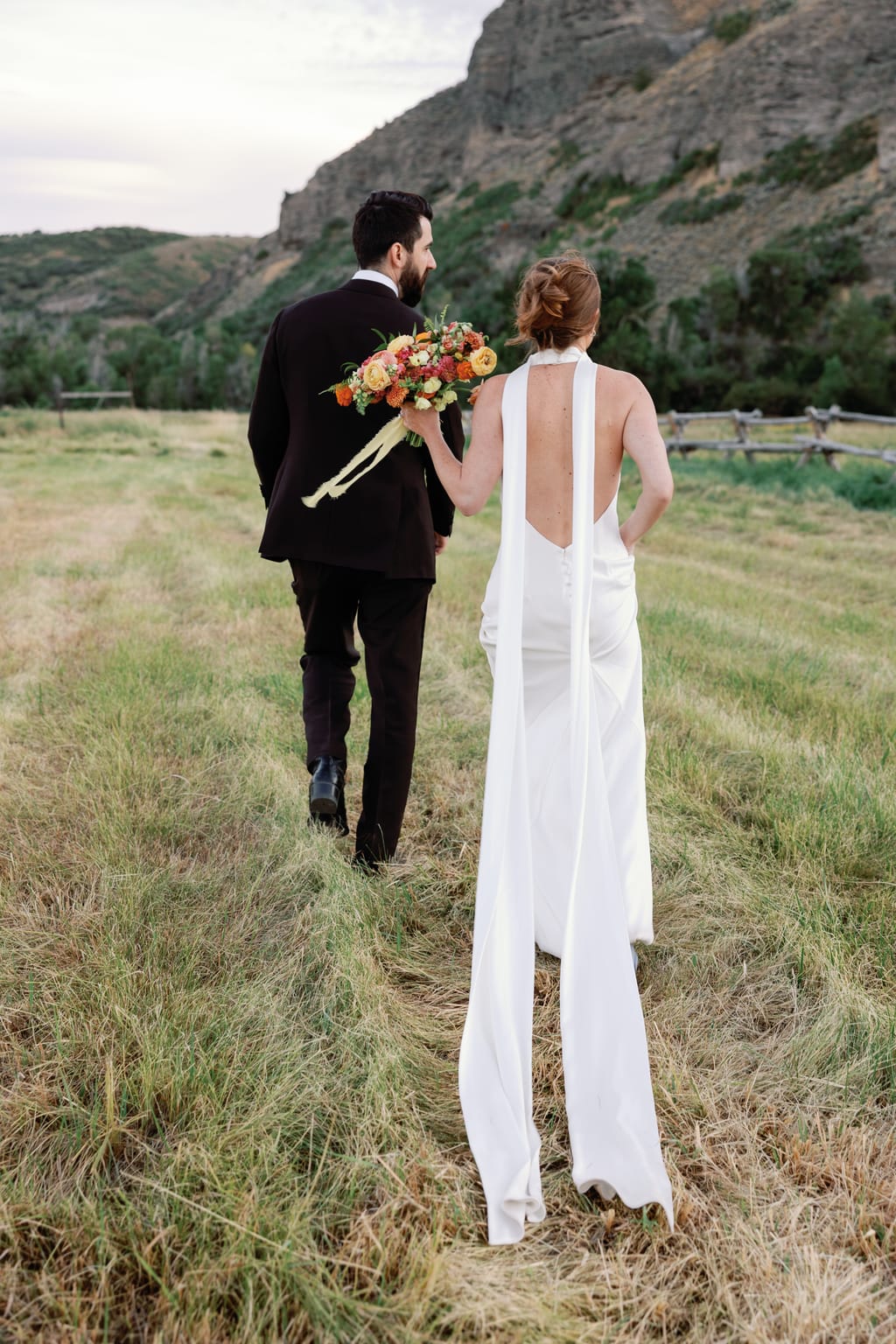 Bride and groom at dusk in the meadow below the butte, 4U Ranch wedding, Park City Utah