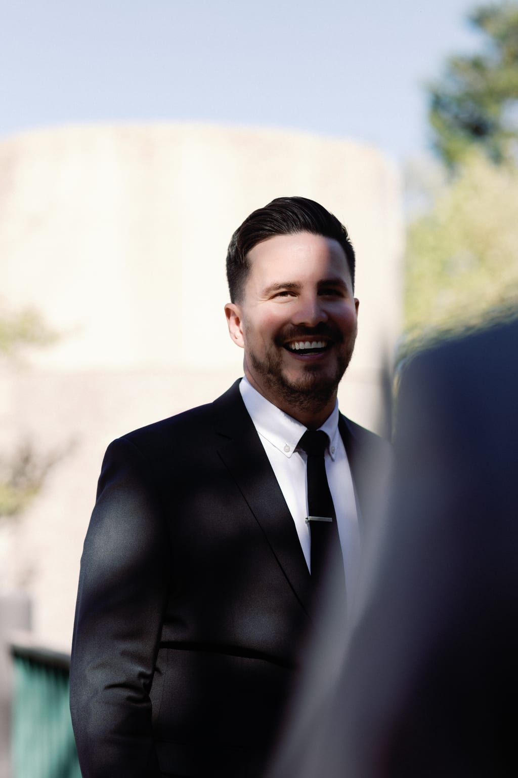 Portrait of the groom in his black suit, Sundance mountain wedding