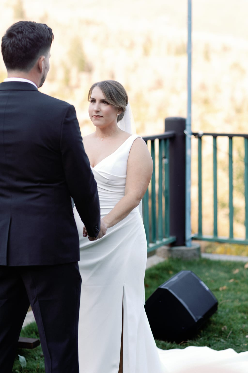 The couple holding each other during the ceremony, private Sundance residence