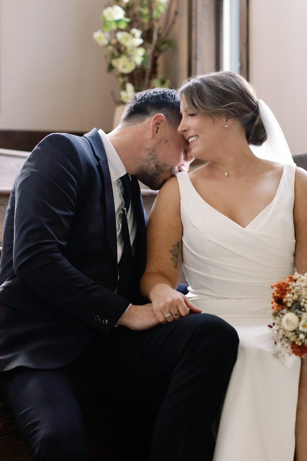An intimate kiss with the bridal bouquet, private Sundance residence